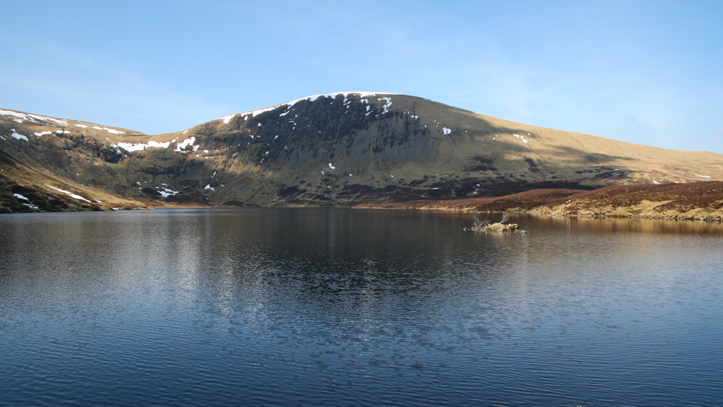 View across a loch looking at a mountain